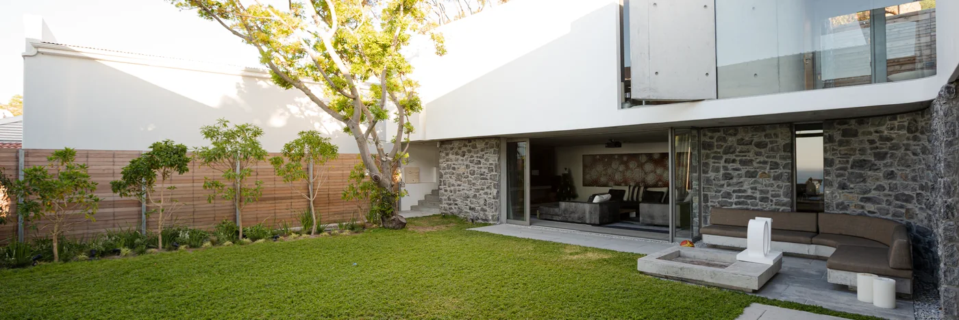 A clean rectangular lawn behind a modern house